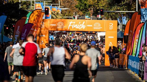 Sydney Half content runners finish arch 2023